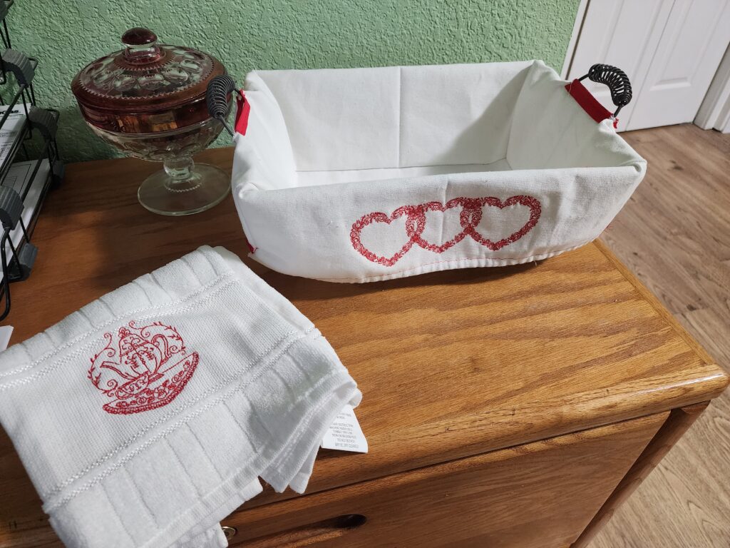 White fabric basket with red embroidered hearts
